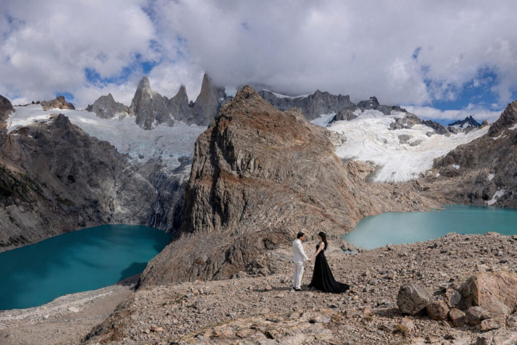 Bride and groom, bride in black and groom in white, eloping at Torres del Paine
