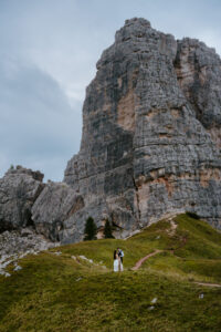 Cinque Torri Elopement with couple looking small against giant rocks