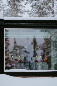 Akaslompolo Finland Winter Engagement couple kissing inside cabin