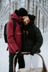 Akaslompolo Finland Winter Engagement happy couple on dog sled