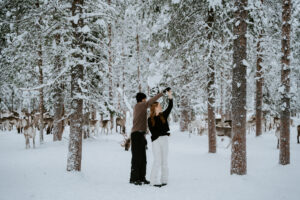 Akaslompolo Finland Winter Engagement couple dancing in the snow