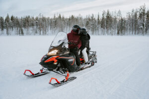 Akaslompolo Finland Winter Adventure Engagement snowmobiling couple