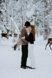 Akaslompolo Finland Winter Engagement happy couple with reindeer and snow