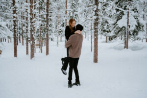 Akaslompolo Finland Winter Engagement couple having fun in the snow