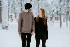 Akaslompolo Finland Winter Engagement couple walking in the snow