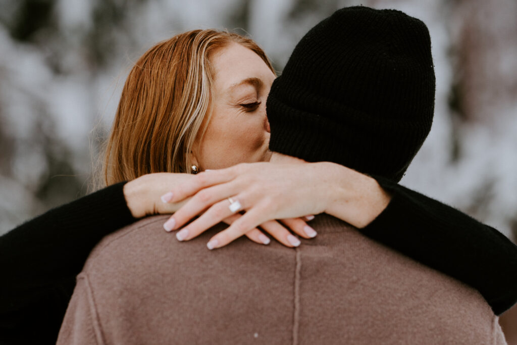 Akaslompolo Finland Winter Engagement bride to be kissing husband to be