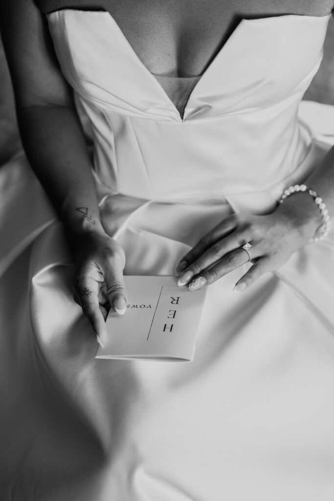 Vow booklet on lap of bride at Croatia wedding