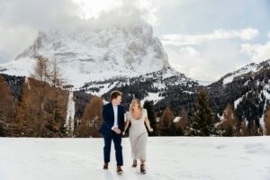 Passo Gardena Dolomites Winter Engagement, couple frolics through the snow