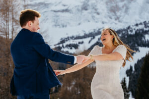 Passo Gardena Dolomites Winter Engagement, dancing in circles while laughing