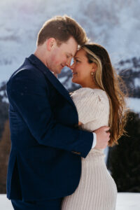 Passo Gardena Dolomites Winter Engagement, women covers her arms with man's jacket from the cold