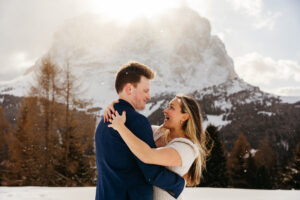 Passo Gardena Dolomites Winter Engagement, bride to be smiles at groom to be in the snow
