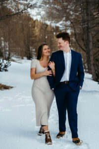 Passo Gardena Dolomites Winter Engagement, couple walking through the snow in cute winter outfits
