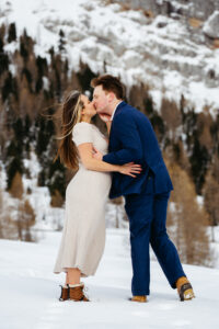 Passo Gardena Dolomites Winter Engagement, woman and man kiss in snow