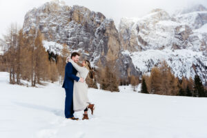 Passo Gardena Dolomites Winter Engagement, couple making silly faces at each other in the snow