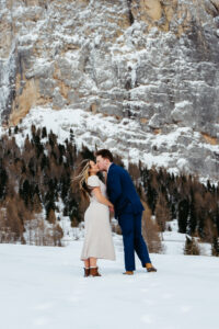 Passo Gardena Dolomites Winter Engagement, engaged couple kissing in the snow