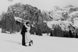 Passo Gardena Dolomites Winter Engagement, black and white of kissing couple in the snow
