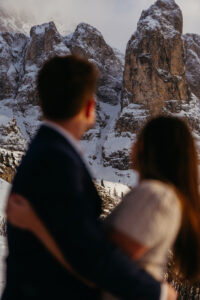 Passo Gardena Dolomites Winter Engagement, focus on the mountains with couple out of focus