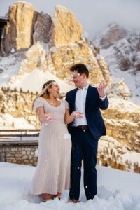 Passo Gardena Dolomites Winter Engagement, couple throws snow in the air