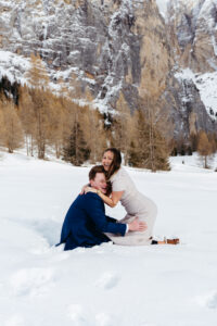 Passo Gardena Dolomites Winter Engagement, couple trips and laughs in the snow