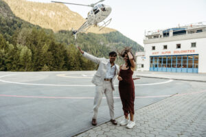 helicopter takes off behind couple after engagement