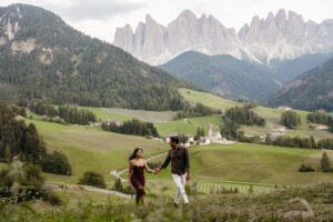 Couple frolicking through Val di Funes after their engagement