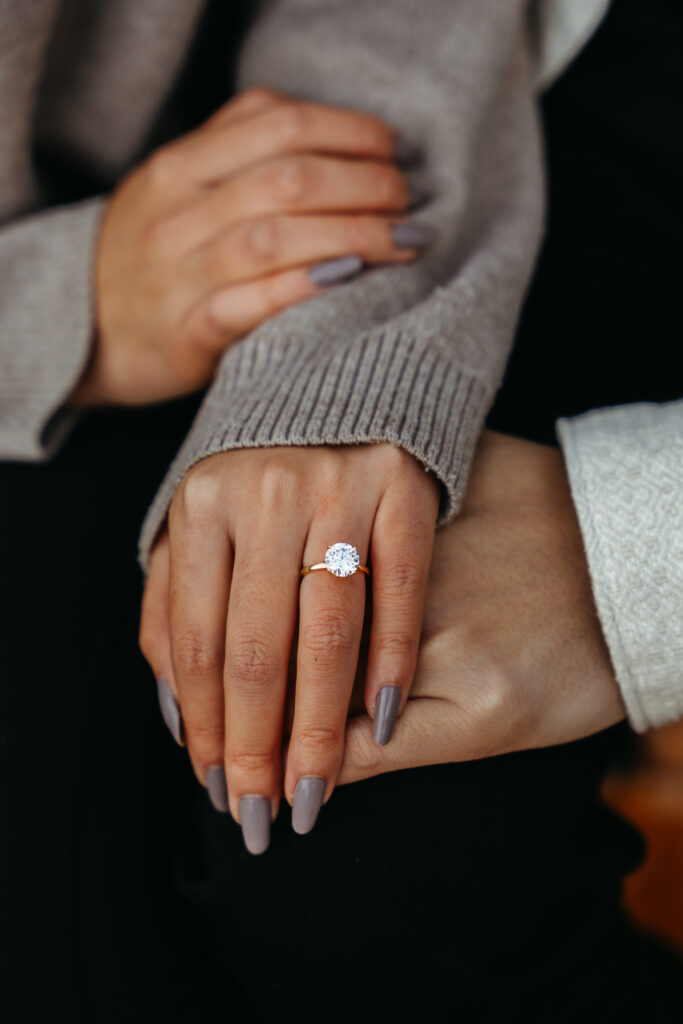 Proposal ring on bride-to-be's finger at Lago di Braies in the Dolomites