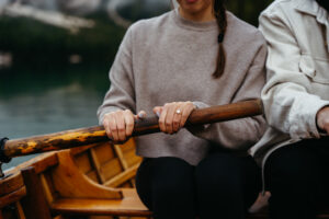 Girl's hand with engagement ring on paddle at Pragser Wildsee engagement