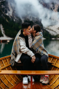 Girl kissing boy on boat at Lago di Braies