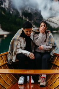 Couple laughing on boat at Lago di Braies engagement