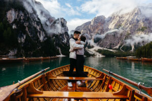 Couple kissing on boat at La Palifitta boathouse on Pragser Wildsee