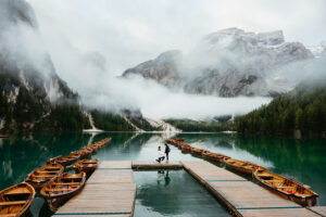 Asian man on one knee proposing to girlfriend at Lago di Braies