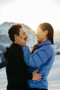 Sunrise over Platkofel with a newly engaged couple posing for photos in winter