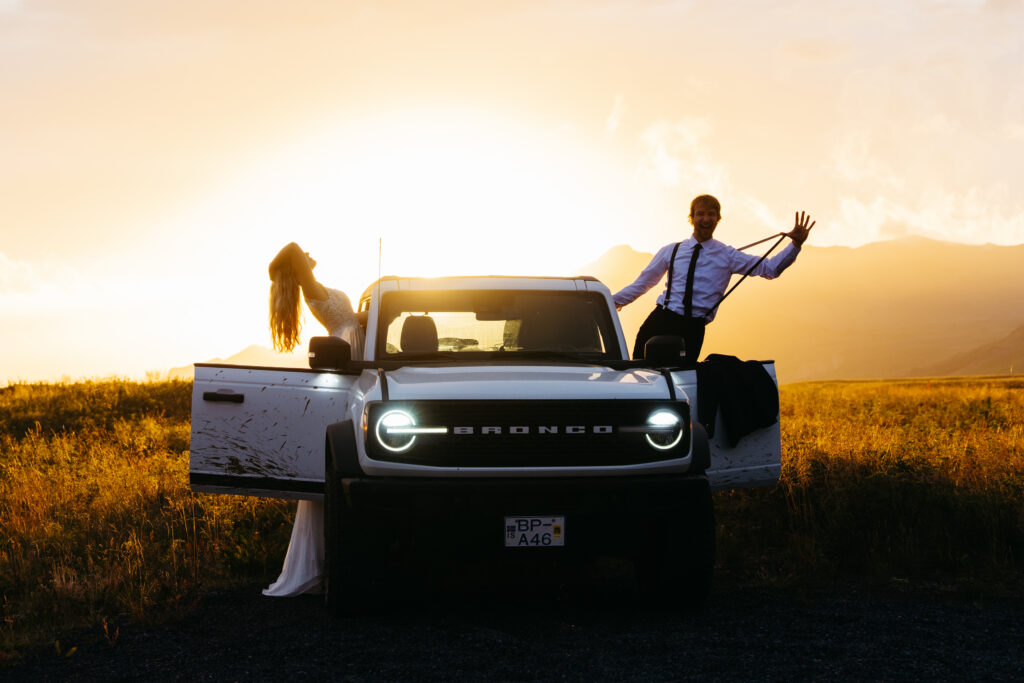 couple eloping in Iceland with 4x4 at sunset