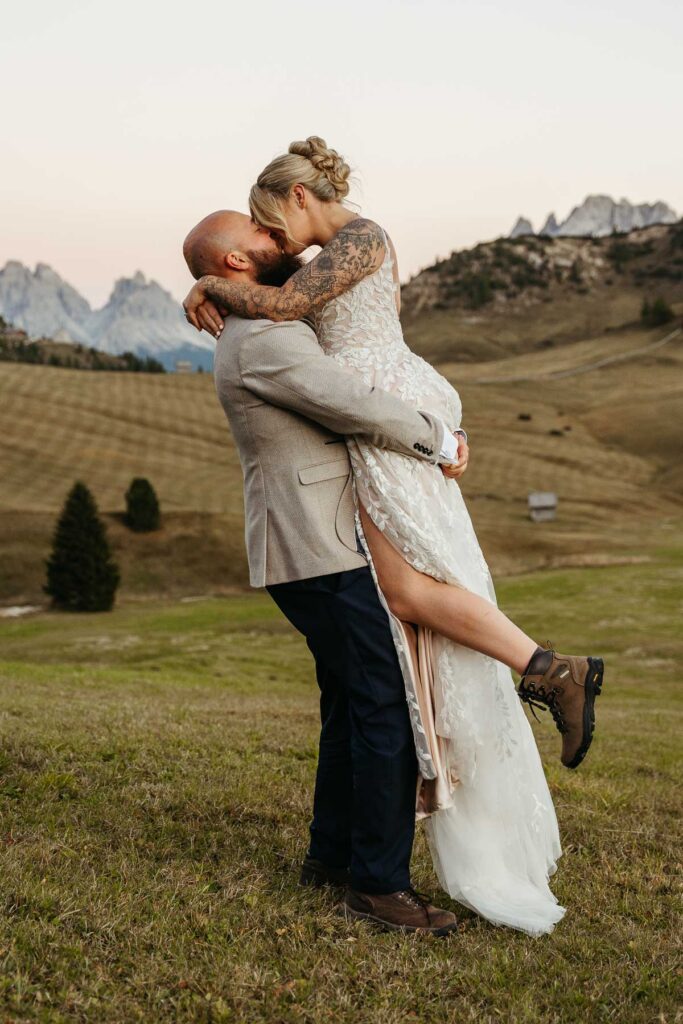 Groom lifting bride at Prato Piazza during their eco-friendly elopement