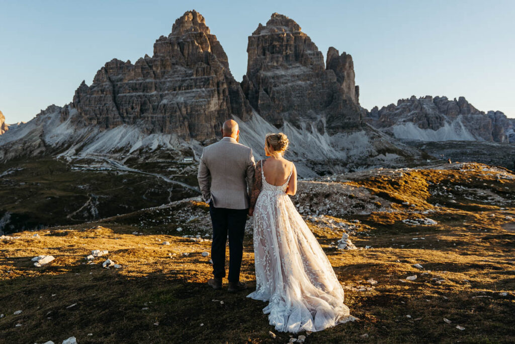 Tre Cime at sunrise with bride and groom standing in front