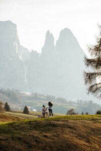 Man proposing to woman at sunset in Alpe di Siusi