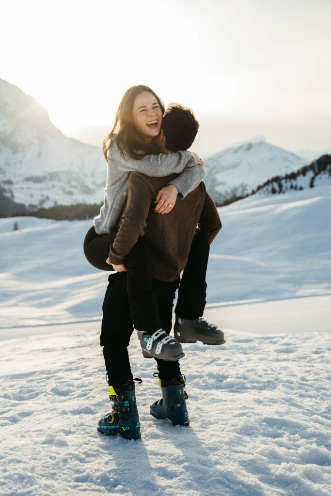 Couple after proposal, with ski boots on in winter, on Alpe di Siusi