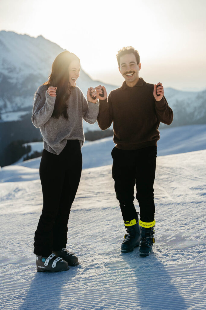 Couple using sustainable reusable handwarmers in the winter after their proposal on Alpe di Siusi