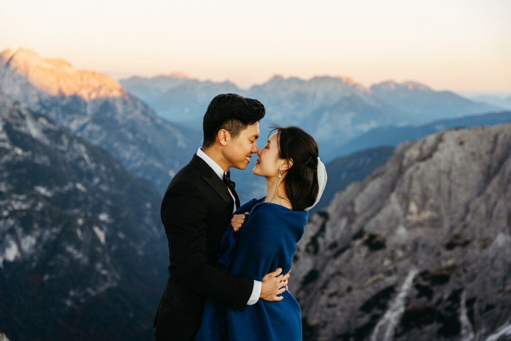 Bride and groom getting cozy with blanket during ultimate autumn elopement destination