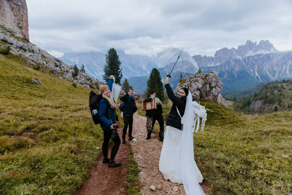 Vegan photographer Shawna Rae, her bride, groom, and content creator prepared for the rain on the elopement day