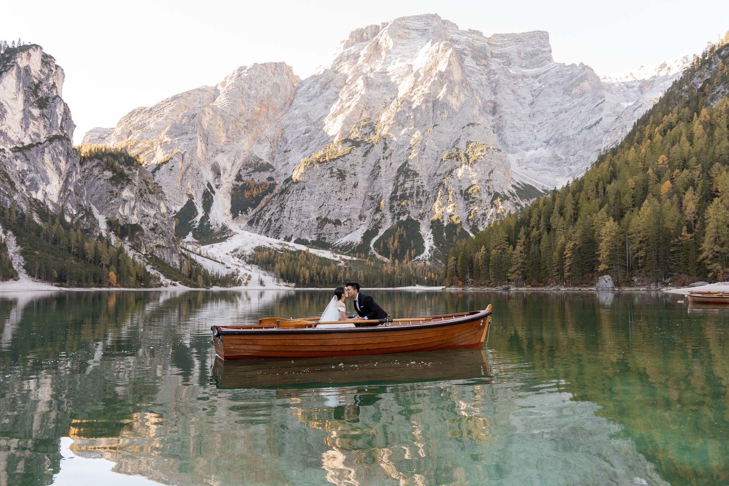 Bride and groom boating on Lago di Braies during their elopement