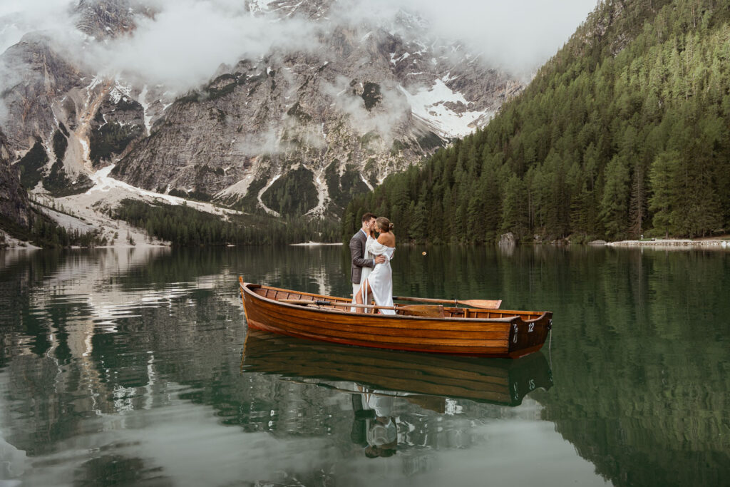 Wife and husband renewing their vows on a boat from La Palifitta at Lago dir Braies