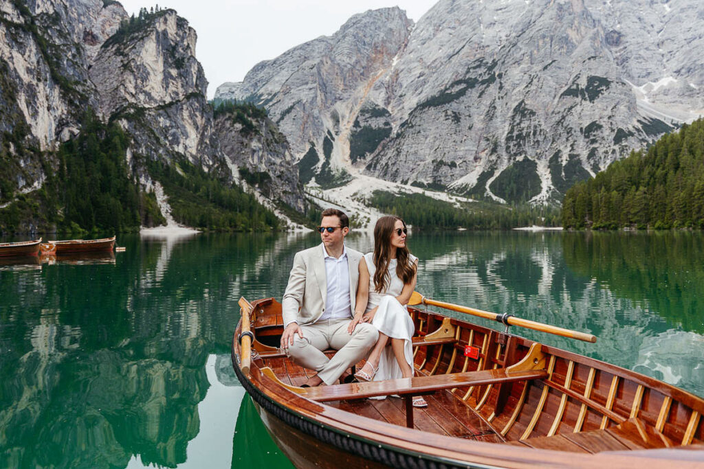 Bride and groom looking super cool as they sit on a boat rented from La Palifitta at Lake Braies