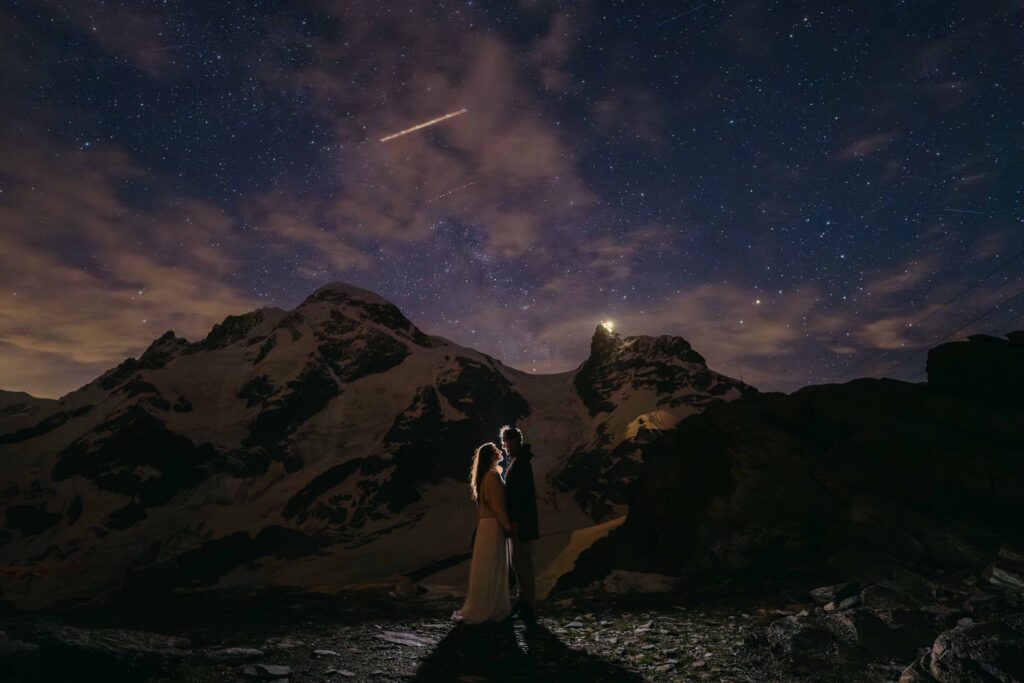 Bride and groom star gazing in Switerland for their elopement with mountains
