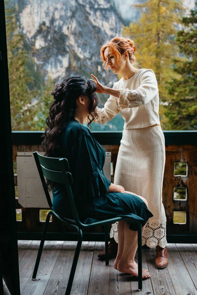 Elopement vendor doing hair on bride on her wedding day at Lago di Braies