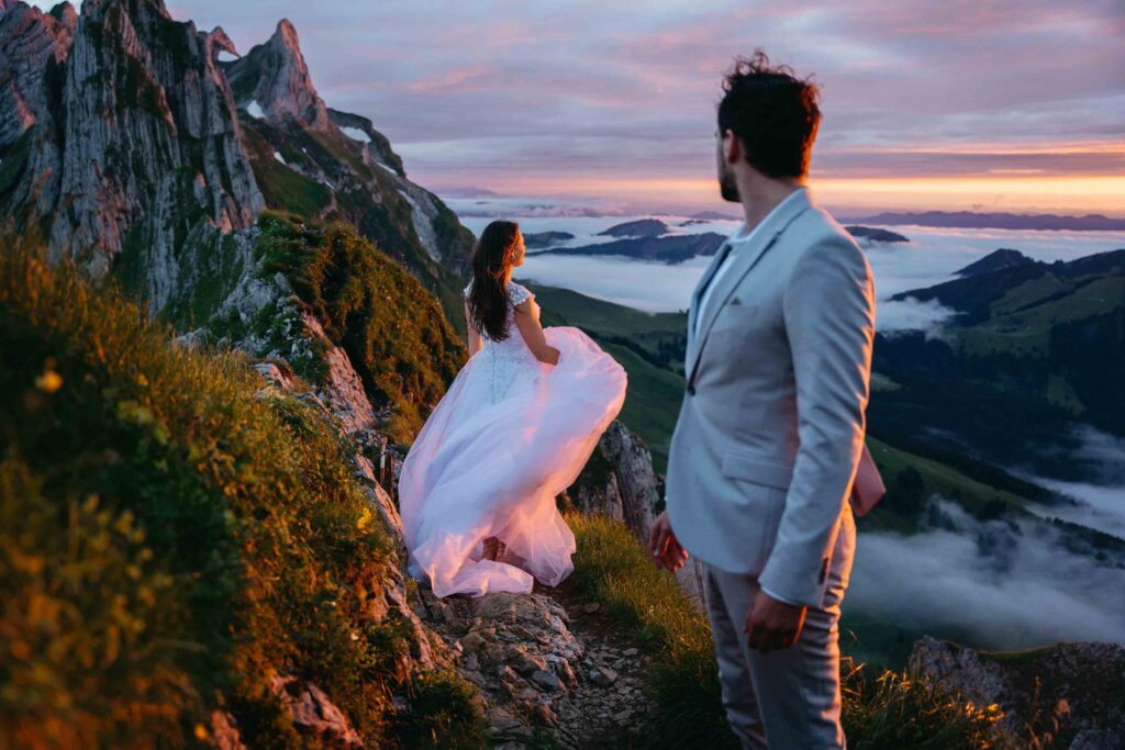 Bride and groom during sunset on a mountian top in Switzerland with epic views