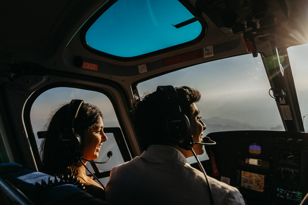 Engaged couple enjoying helicopter ride over the Dolomites