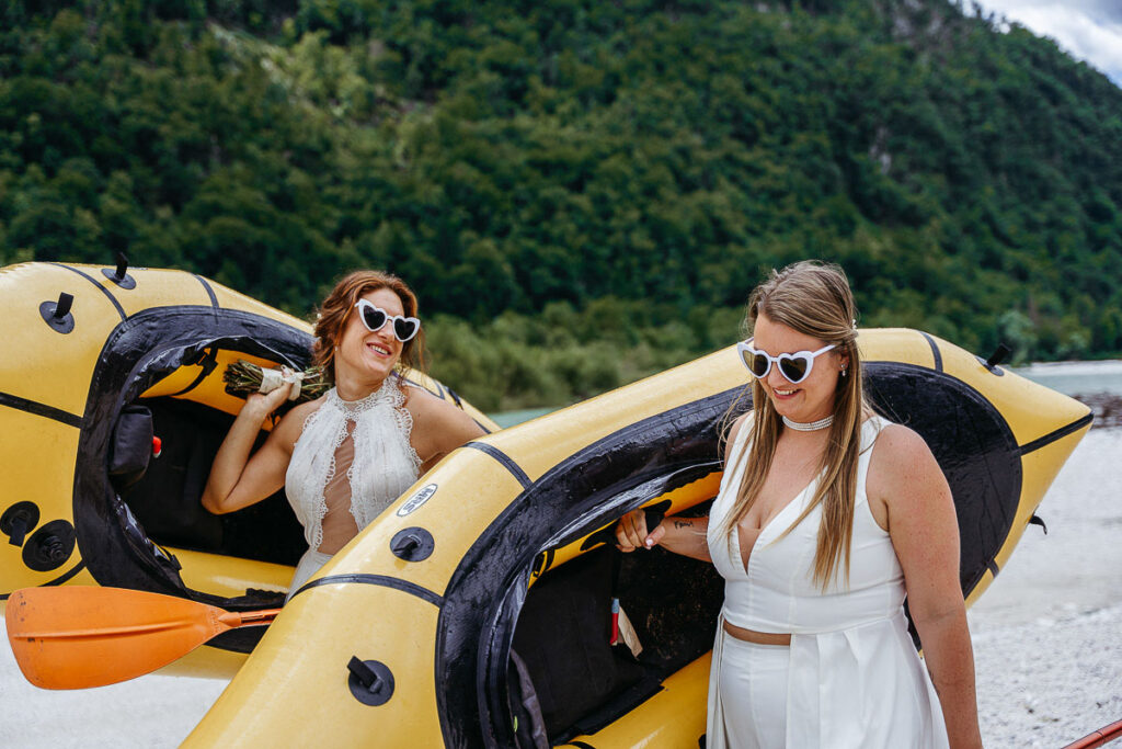 Bride and bride on their elopement day pack rafting on the Soča River in Slovenia. Things to do on your elopement day