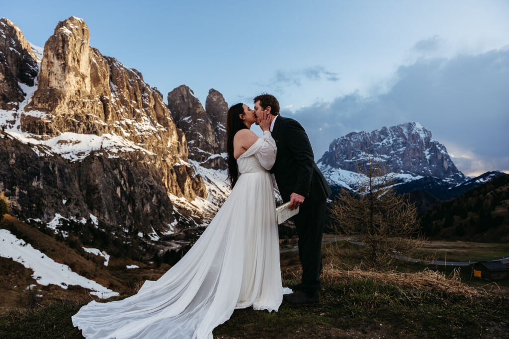 Sunset at Passo Gardena with husband and wife kissing after they renewed their vows
