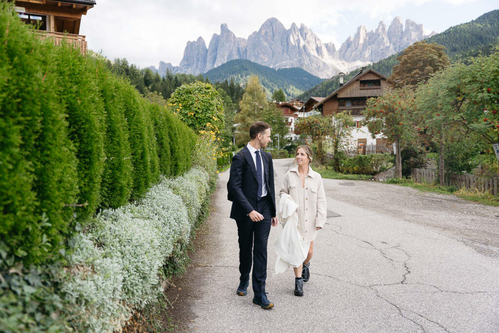 Bride and groom walking during autumn at Val di Funes, autumn is the ultimate elopement time